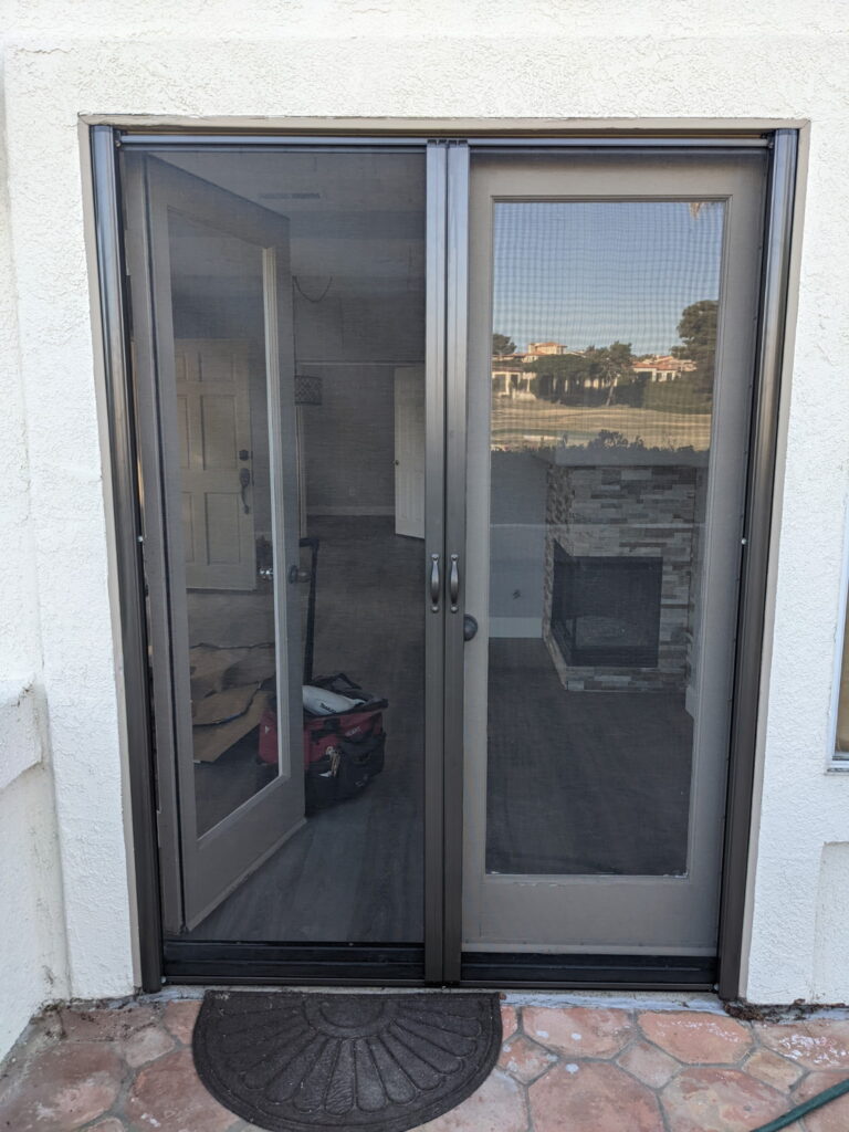 Double retractable screens over a patio slider, installed by Screen Repair Orange County