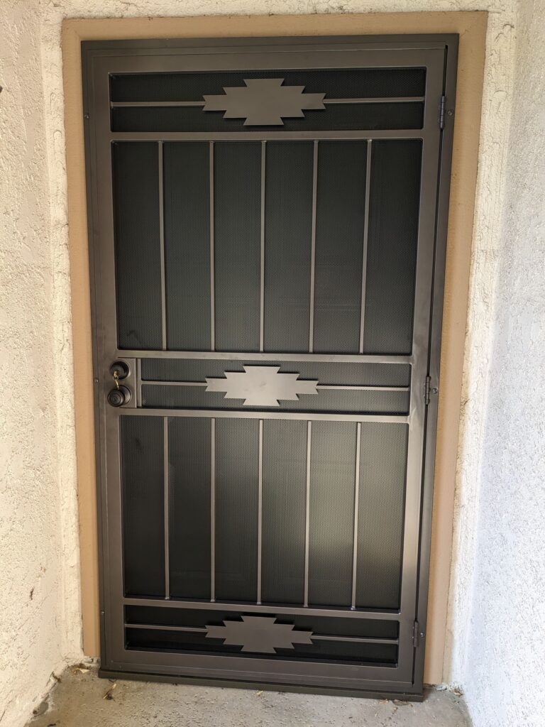 Security screen doors with decorative scrollwork installed on a stucco home entry in Orange County